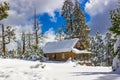 Cabin Covered In Snow At Top Of Hill