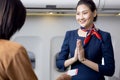 Cabin crew or Stewardess greeting passengers on airplane, Air hostess or stewardess service