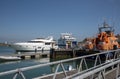 Cabin cruiser, ferry and lifeboat. Yarmouth harbour, Isle of Wight, UK