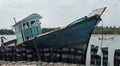 Damaged fisherman boat on a indian small harbor.