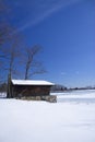 Cabin on frozen lake