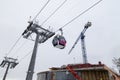 Cabin of a gondola cableway suspended on a rope in the Altai mountains with snow on winter. Ski resorts and snowboarding manzherok