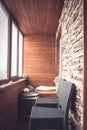 Cabin lodge interior in vintage nautical style decorated with wood planks and stone with big windows wooden barrel and bar chairs