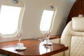 Cabin of luxury private jet. Empty aircraft with white leather chairs. Royalty Free Stock Photo