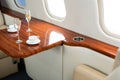 Cabin of luxury private jet. Empty aircraft with white leather chairs. Royalty Free Stock Photo