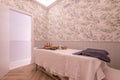 Cabin with massage table with towels and wood therapy utensils and treatments from a beauty salon and aesthetic care