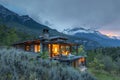 A cabin nestled in the mountains with a breathtaking view of the mountain range, A cozy cabin nestled in the mountains with a