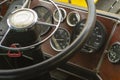 The cabin of the old bus. Vintage dashboard. Leather steering wheel