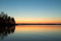 Cabin on the point reflecting in the lake with spring sunset Royalty Free Stock Photo