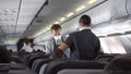 Cabin of the S7 airline, stewards carry water to passengers.