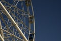 Cabin and support of a ferris wheel on a background of clear blue sky