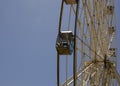 Cabin and support of a ferris wheel on a background of clear blue sky