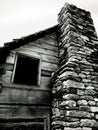 Cabin Window with Stone Chimney