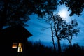 Cabin in the Woods lit with Moonlight Royalty Free Stock Photo