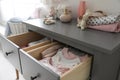 Cabinet drawers with baby clothes in child room Royalty Free Stock Photo
