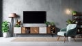 Cabinet TV in a modern living room with an armchair, lamp, table, flower, and plant on a concrete wall background Royalty Free Stock Photo