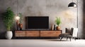 Cabinet TV in a modern living room with an armchair, lamp, table, flower, and plant on a concrete wall background Royalty Free Stock Photo