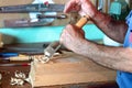 Cabinetmaker carving a piece of wood with chisel