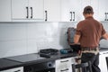 Cabinetmaker Finishing New Kitchen Cabinets Installation