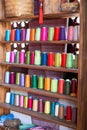 The cabinets of the Chinese tailor shop are filled with cotton thread spools of various colors Royalty Free Stock Photo