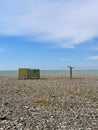 Cabins for changing clothes and showers on a pebble beach by the sea