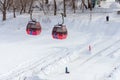 The cabins of funiculars over the frozen river and ice slides Royalty Free Stock Photo