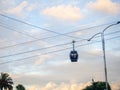 Cabins on a rope. Ropeway. Cabin silhouette. Road in the city on a lift