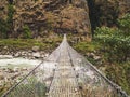 Cable bridge over the river valley in Annapurna range Nepal Royalty Free Stock Photo