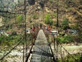 Cable bridge with prayer flags in Annapurna range Nepal Royalty Free Stock Photo