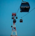 Cable car against the backdrop of deep sunset, silhouettes of cabins in the sky, cables, warm light, evening romance and Royalty Free Stock Photo