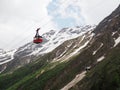 Cable car in the background of the mountains Old red cable car at mountain and yellow new. Russia, Elbrus - June 2019