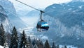 A cable car cabin gliding over a snowy valley in the mountains Royalty Free Stock Photo