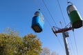 Cable car with colored cabins in autumn.