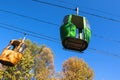 Cable car with colored cabins in autumn.