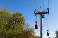 Cable car with colored cabins in autumn.