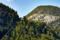 Cable car, forest and mountains over the Austrian city of Hallstatt, under a blue sky