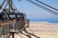 Cable car full of tourists located at the top of the fortress of Masada
