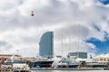 Cable car that goes up to the Montjuic mountain in Barcelona passing over the dry dock of the port of Barcelona with luxury yachts