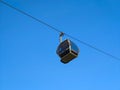 Cable car gondola elevator cabin on the steel cable with a blue sky