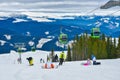 Cable car gondola ski lift and skiers on the slope in Voineasa, Romania Royalty Free Stock Photo