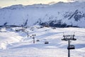 Cable car gondola at ski resort with snowy mountains on background. Modern ski lift with funitels and supporting towers Royalty Free Stock Photo