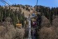 Cable car with lifting mechanisms in the mountains on a clear sunny day against a blue sky. Active recreation and winter sports