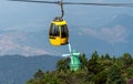 Cable car over old windmill and green forest. Mountains summer landscape Royalty Free Stock Photo
