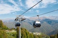 Cable car road with grey cabines at mountain landscape. Sochi, Rosa Khutor