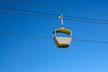 Cable car on rope of cableway, blue clear sky background in sunny summer day Royalty Free Stock Photo