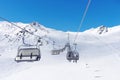 Cable car at a ski resort. Skiers ascend the mountain in the chair lift Royalty Free Stock Photo