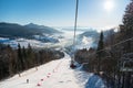 Cable car with skiers in Bukovel at sunny day