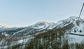 Cable car in spring evening overlooking the tops of the mountains