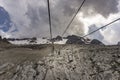 Cable car to the Marmolada massif under a dramatic, stormy sky.