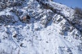 Cable car way on snowy mountains background. Gondola lift in winter mountains.